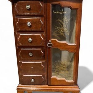 Vintage wooden armoire-style jewelry box with six drawers and an etched door